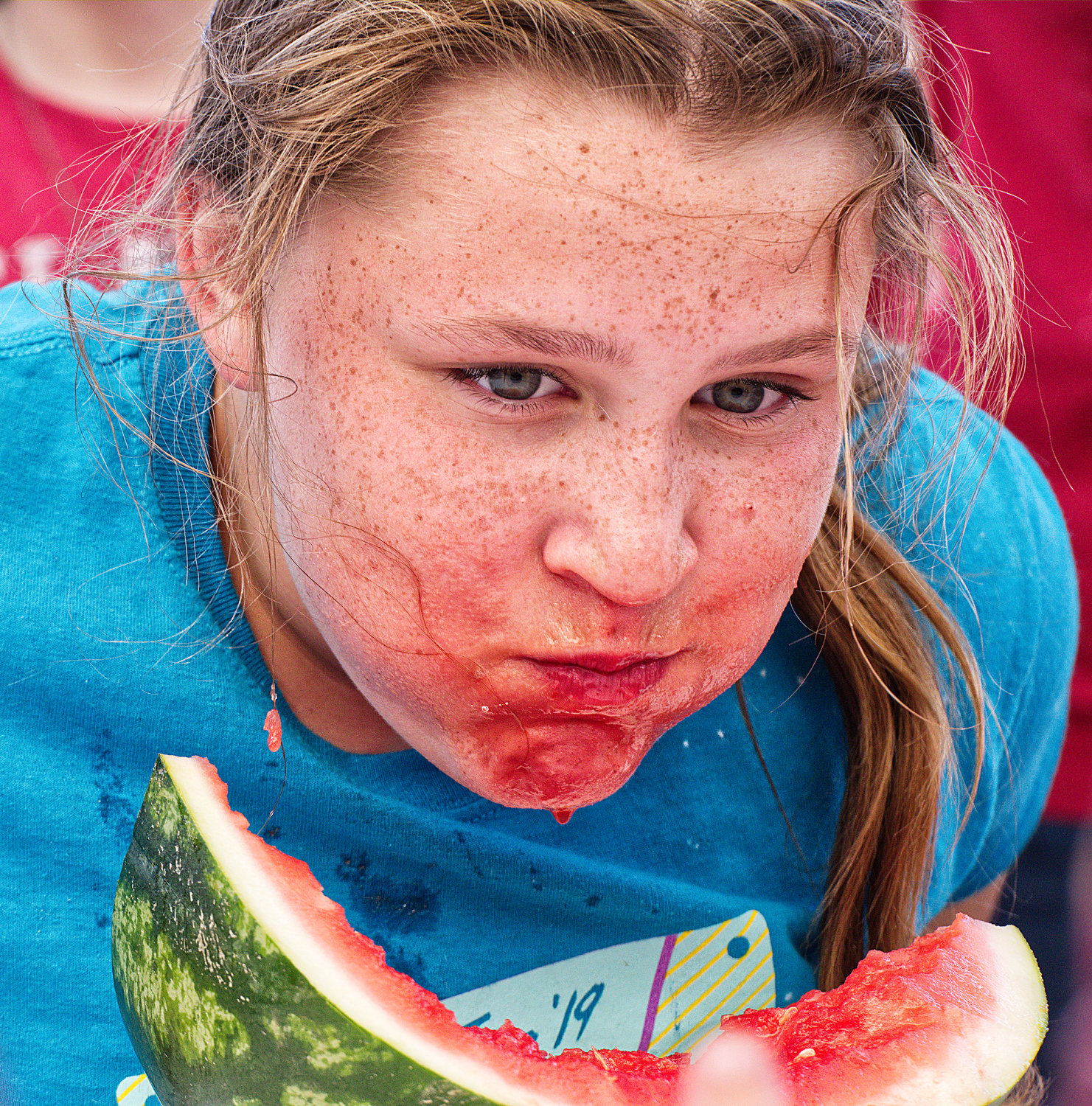 Carlee Cain of Mineola competes in the watermelon-eating contest during the Iron Horse Festival Saturday in downtown Mineola, which she won.